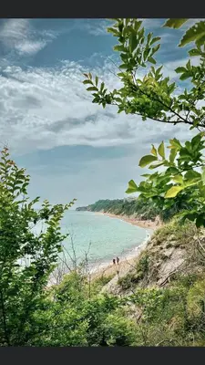 a beach with people walking on the sand and the water at Summer Rose Studio by the Sea in Byala
