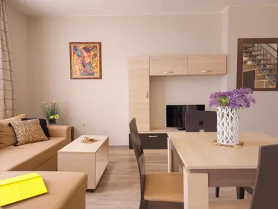 a living room with a couch and a table at Sorrento Sole Mare Apartments in Sveti Vlas
