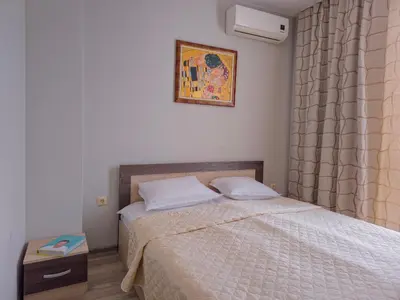 a bedroom with a bed and a picture on the wall at Sorrento Sole Mare Apartments in Sveti Vlas