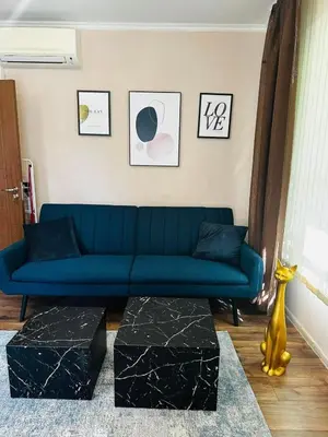 a living room with a blue couch and a table at Varna Top Center 1 in Varna City