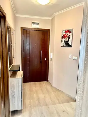 a hallway with a wooden door in a house at Varna Top Center 1 in Varna City