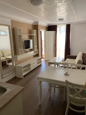a living room with a couch and a table at Penthouse Happy Moments 4 in Sunny Beach