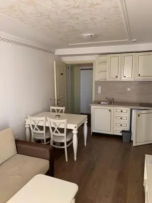 a living room with a table and a kitchen at Penthouse Happy Moments 4 in Sunny Beach