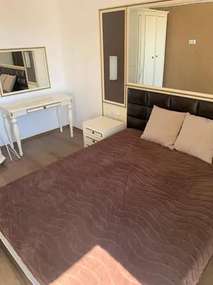 a bedroom with a large bed and a desk at Penthouse Happy Moments 4 in Sunny Beach