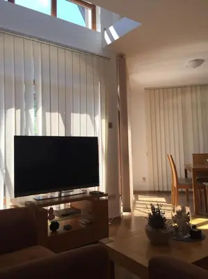 a living room with a large flat screen tv at STUNNING VILLA with PRIVATE POOL in Kableshkovo