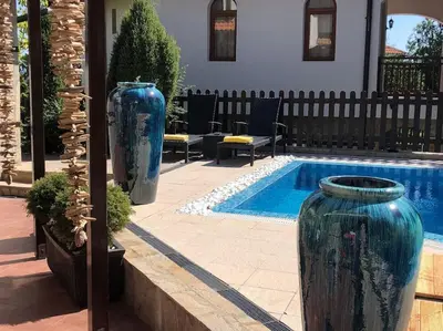 two large blue vases sitting next to a swimming pool at STUNNING VILLA with PRIVATE POOL in Kableshkovo
