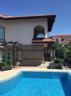 a swimming pool in front of a house at STUNNING VILLA with PRIVATE POOL in Kableshkovo