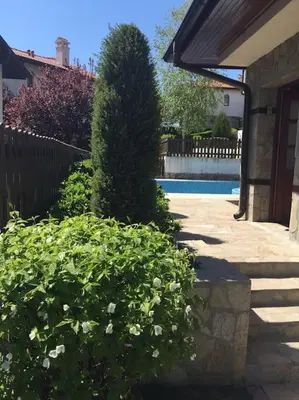 a yard with a fence and a pool and some bushes at STUNNING VILLA with PRIVATE POOL in Kableshkovo