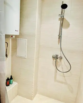 a shower with a shower head in a bathroom at Good Mood Studio in Green Life First Line in Sozopol