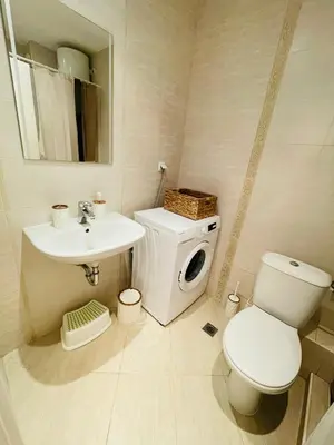 a white bathroom with a toilet and a sink at Good Mood Studio in Green Life First Line in Sozopol