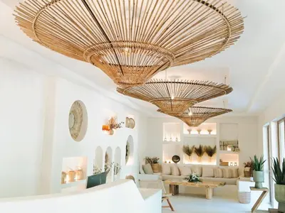 a living room with two large gold chandeliers at PARADISE Bay Hotel in Sozopol