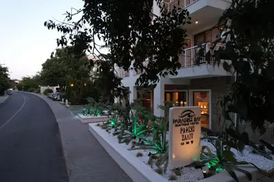 a sign in front of a building on a street at PARADISE Bay Hotel in Sozopol