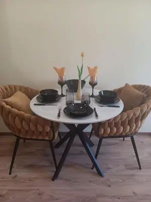 a table and two chairs with plates and glasses on it at One-room boutique at Sunrise All Suites in Obzor