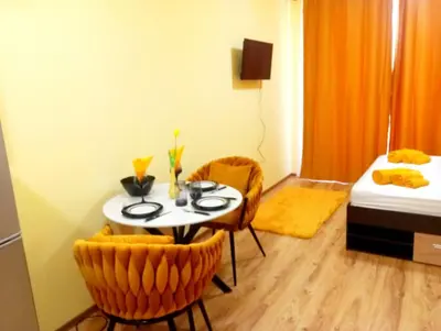 a small room with a table and two chairs at One-room boutique at Sunrise All Suites in Obzor