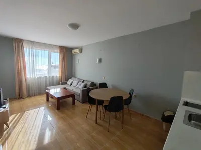 a living room with a table and a couch at Magic Dreams Apartments in Sveti Vlas