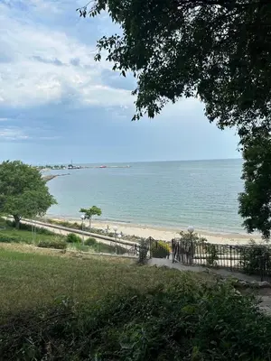 a view of a beach with a fence and the ocean at Seaside Apartment Nesebar in Nesebar