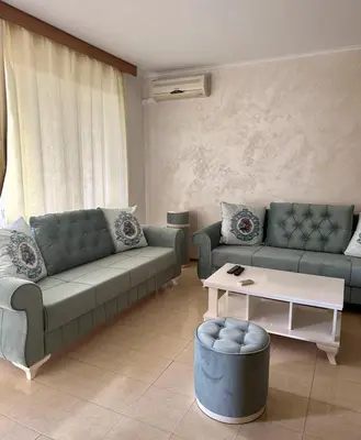 a living room with two couches and a coffee table at Seaside Apartment Nesebar in Nesebar