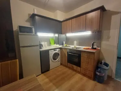 a small kitchen with a washing machine and a washer at Reina Apart Flores Park in Sunny Beach