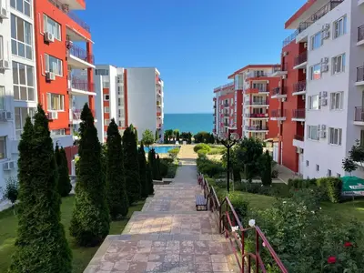 a walkway in a city with tall buildings at Peter Apartmanbulgaria-Crown Fort Noks in Sveti Vlas