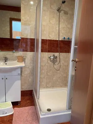 a bathroom with a shower and a sink at Peter Apartmanbulgaria-Crown Fort Noks in Sveti Vlas