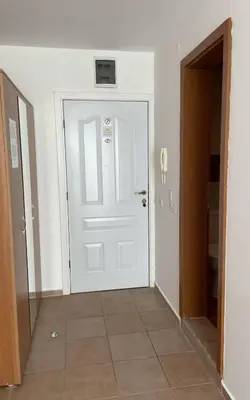 an empty hallway with a white door and a doorway at Peter Apartmanbulgaria-Crown Fort Noks in Sveti Vlas