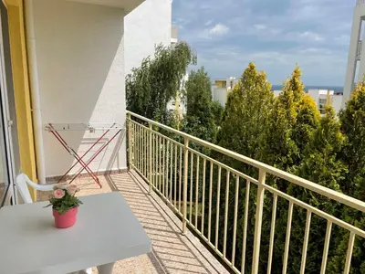 a balcony with a white table and a plant on it at Peter Apartmanbulgaria-Crown Fort Noks in Sveti Vlas