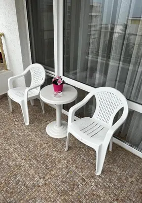 two white chairs and a table on a porch at Peter Apartmanbulgaria-Imperial Fort Noks in Elenite