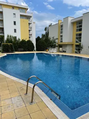 a large swimming pool in front of two buildings at Peter Apartmanbulgaria-Imperial Fort Noks in Elenite