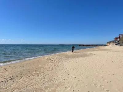 a person standing on a sandy beach near the ocean at Peter Apartmanbulgaria-Imperial Fort Noks in Elenite