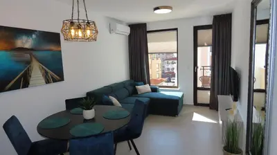 a living room with a couch and a table at Polarstar Apartment Verona in Sveti Vlas