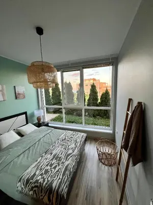 a bedroom with a bed and a large window at Black Sea Breeze Apartment No 3 in Byala