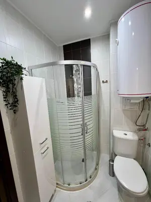 a bathroom with a shower and a toilet in it at Black Sea Breeze Apartment No 3 in Byala