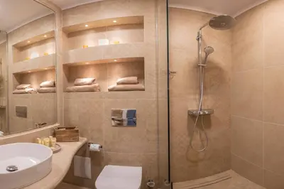 a bathroom with a shower and a toilet and a sink at Marina Varna Apartment-2BDR at South Bay Complex in Varna City