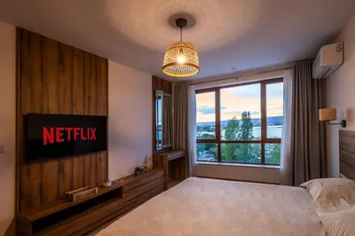 a bedroom with a bed and a large window at Marina Varna Apartment-2BDR at South Bay Complex in Varna City
