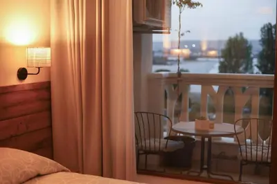 a bedroom with a balcony with a table and chairs at Marina Varna Apartment-2BDR at South Bay Complex in Varna City