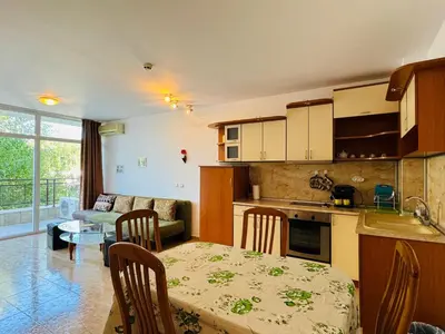 a kitchen and a living room with a table and a dining room at SUN VILLAGE B 320 Apartment Sunny Beach in Sunny Beach