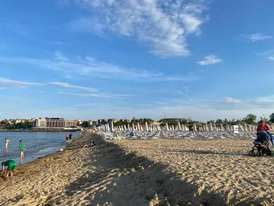 a group of people on a sandy beach at SUN VILLAGE B 320 Apartment Sunny Beach in Sunny Beach