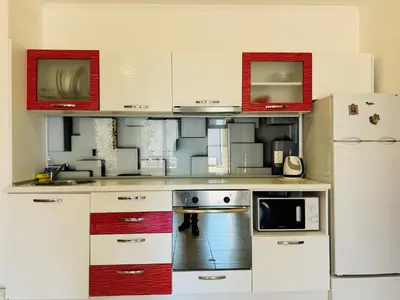 a kitchen with white cabinets and a refrigerator at VODENICATA 3 Apartament Sveti Vlas in Sveti Vlas