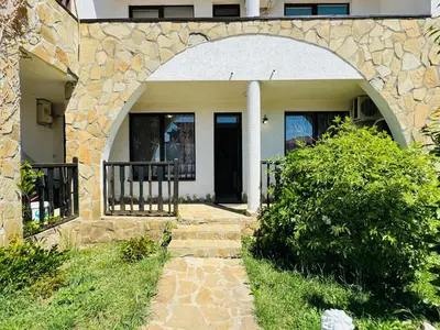 a stone house with an arched doorway and a walkway at VODENICATA 3 Apartament Sveti Vlas in Sveti Vlas