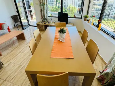 a dining room with a table and chairs at VODENICATA 7 Apartment Sveti Vlas in Sveti Vlas