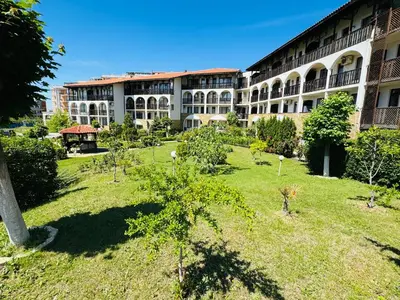 a large building with a garden in front of it at VODENICATA 7 Apartment Sveti Vlas in Sveti Vlas