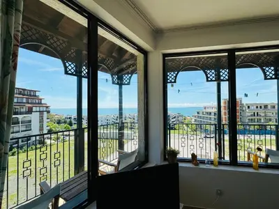 a room with windows with a view of the city at VODENICATA 7 Apartment Sveti Vlas in Sveti Vlas