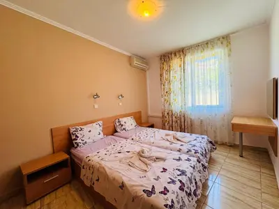 a bedroom with a bed and a window at VODENICATA 4-10 Apartment Sveti Vlas in Sveti Vlas