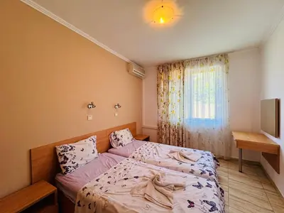 a small bedroom with a bed and a window at VODENICATA 4-10 Apartment Sveti Vlas in Sveti Vlas