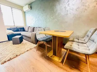 a living room with a table and a couch at Music in the sea in Varna City