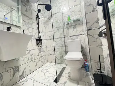 a white bathroom with a toilet and a sink at Music in the sea in Varna City