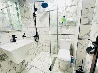 a white bathroom with a sink and a toilet at Music in the sea in Varna City