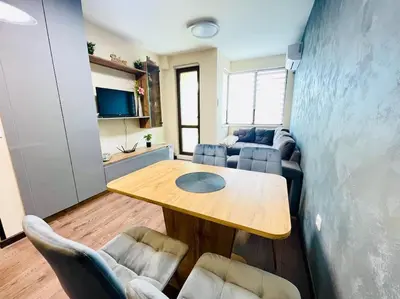 a living room with a table and a couch at Music in the sea in Varna City
