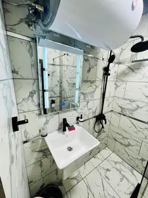 a white bathroom with a sink and a mirror at Music in the sea in Varna City