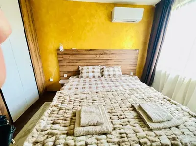 a bedroom with a bed with two towels on it at Music in the sea in Varna City
